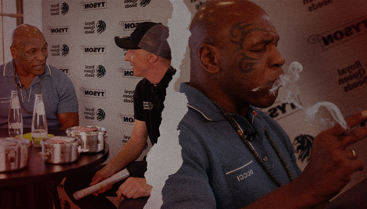Mike Tyson e Royal Queen Seeds – Conversazioni euforiche sulla cannabis Mike Tyson mentre parla e fuma con un rappresentante di Royal Queen Seeds, evidenziando la loro collaborazione nel mondo della cannabis e uno stile di vita euforico.