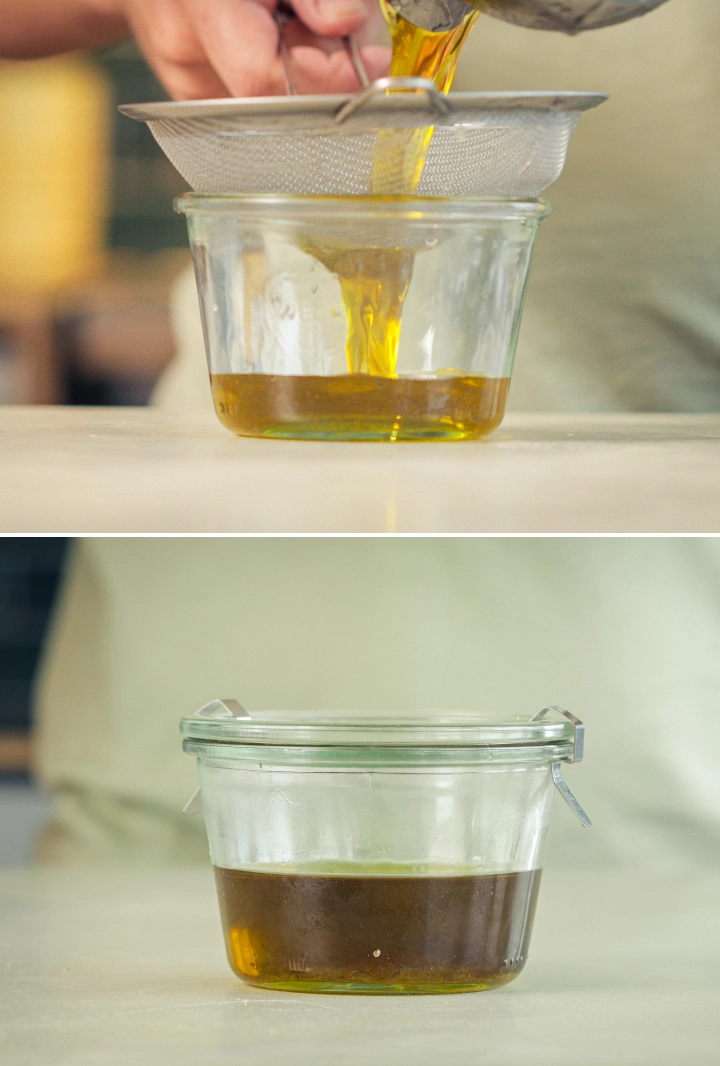 Filtraggio dell’olio d’oliva infuso con cannabis Olio d’oliva infuso con cannabis filtrato attraverso un colino a maglia fine in un contenitore di vetro.