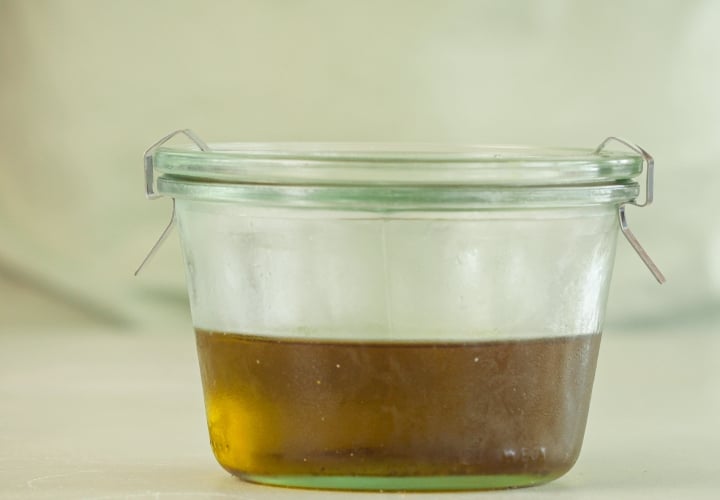 Fase 4: Conservare Correttamente l’Olio MCT alla Cannabis Versare l’olio MCT infuso alla cannabis in una bottiglia di vetro ambrato ermetica per la conservazione, fase finale del processo di infusione